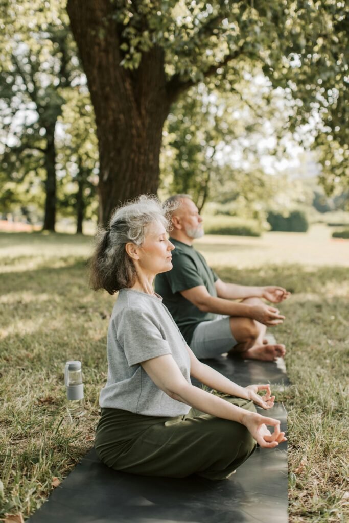 An old couple doing yoga